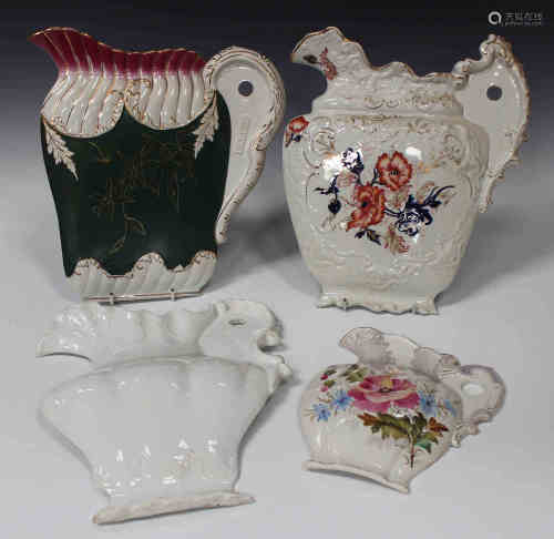 Four pottery half-jug wall plaques, late 19th century, each with different decoration, one white