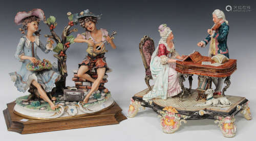 A Continental pottery figure group, early 20th century, modelled as a lady playing a harpsichord and