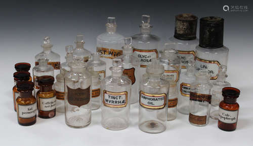 A selection of glass apothecary jars and stoppers, 19th century, mostly clear glass with recessed