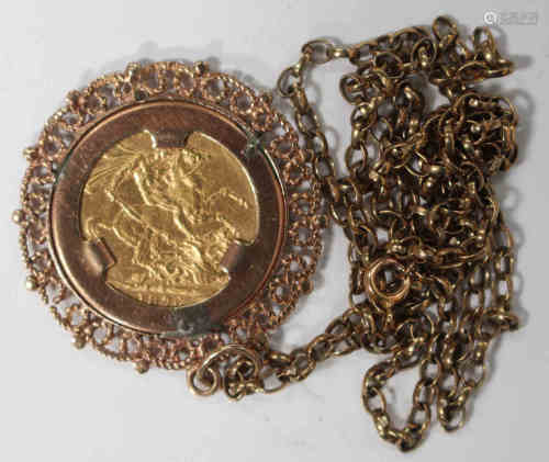 A Victorian Young Head sovereign 1876 in a 9ct gold pendant mount, decorated with a scroll pierced