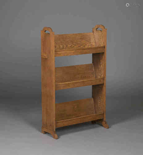 An early 20th century Arts and Crafts oak book trough, the sides with pierced carrying handles above