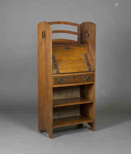 An Edwardian Arts & Crafts oak student's bureau, in the manner of Wylie & Lochhead, the raised