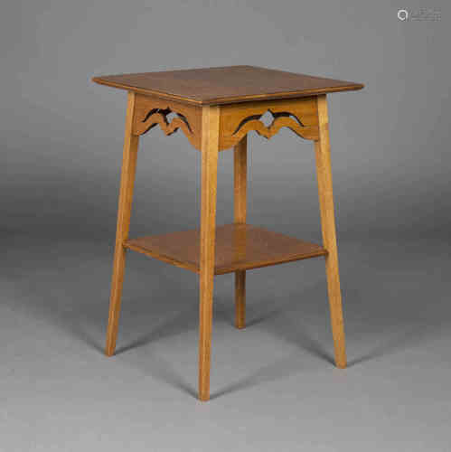 An Edwardian Arts and Crafts oak square occasional table, probably by Liberty & Co, the moulded