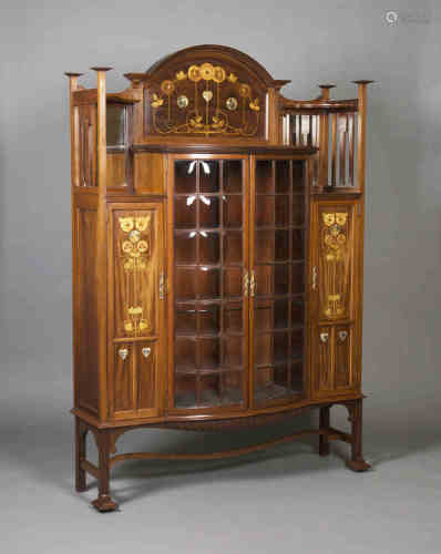 An Edwardian Arts and Crafts mahogany display cabinet by Shapland & Petter of Barnstaple, the raised