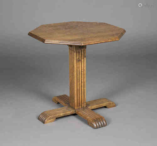 An early 20th century Heals style oak octagonal occasional table, the moulded top above a reeded