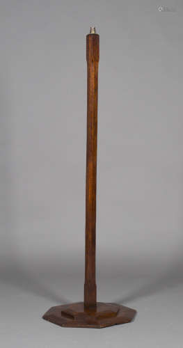 An early 20th century Arts and Crafts oak lamp standard, the chamfered stem on a stepped octagonal