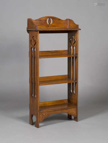 An Edwardian Arts and Crafts oak four-tier open bookcase, in the manner of Liberty & Co, the