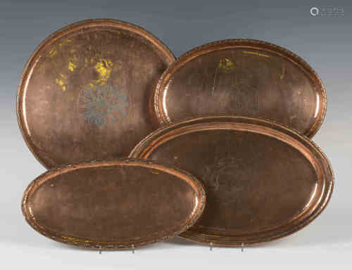A group of four Arts and Crafts copper trays by Hugh Wallace, one engraved with a ship, length 43cm,
