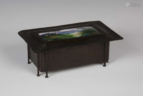 An Edwardian Arts and Crafts patinated copper box, the cover inset with an enamelled landscape view,