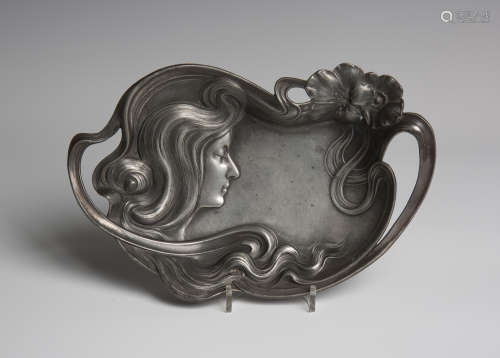 An Art Nouveau WMF cast metal tray, decorated in relief and pierced with a maiden's head,