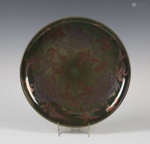 A Jonathan Chiswell-Jones reduction fired lustre pottery charger, decorated with three silver lustre