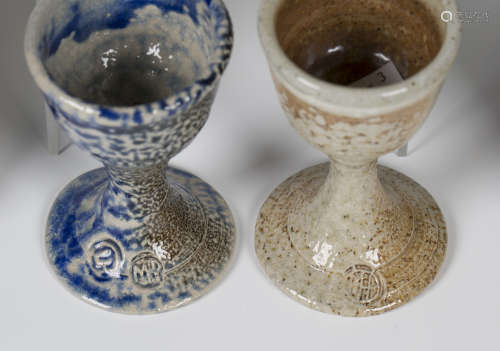 Four Lisa Hammond salt glazed stoneware egg cups, impressed seal marks, heights 9cm and 9.5cm,