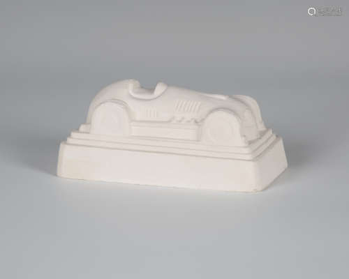 Eduardo Paolozzi - a cast plaster model of a racing car, the underside signed, dated 1997 and