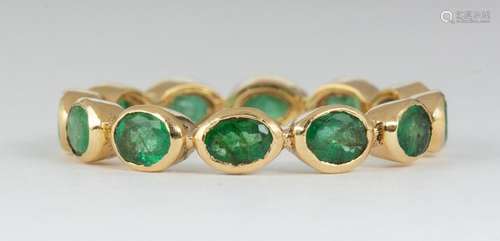 Emerald and 18k yellow gold eternity band