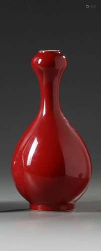 A garlic porcelain vase covered with a red glaze a…