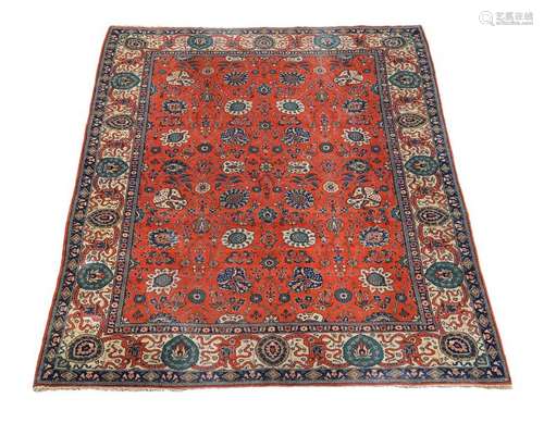 A Tabriz carpet, the vermillion central field with…