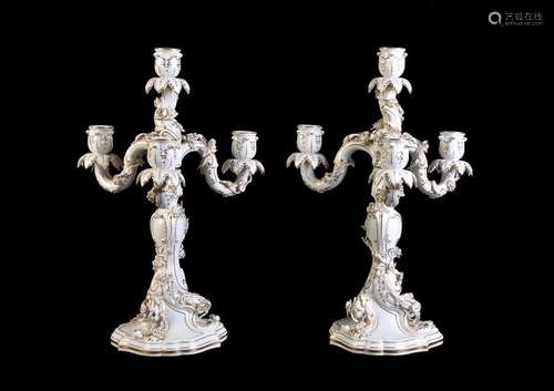 A pair of Meissen white porcelain and gilt four br…