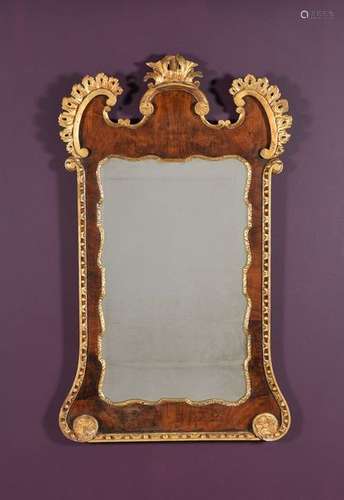 A George II walnut and parcel gilt wall mirror, ci…