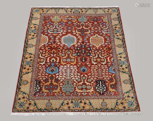 A Tabriz carpet, the madder field decorated with a…