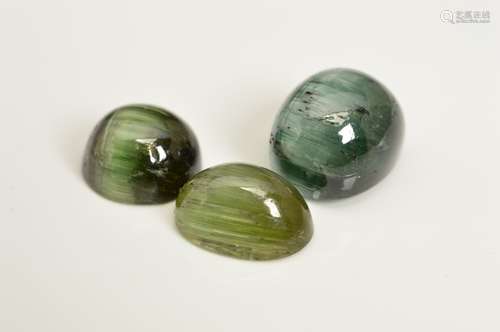 THREE CHATOYANT CABOCHON TOURMALINES, two green, one bluish-green, combined weight 16.88ct