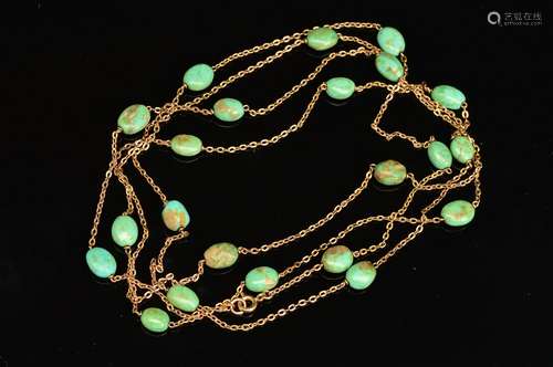 A TURQUOISE GUARD CHAIN, measuring approximately 1400mm in length, comprised oval greenish oval