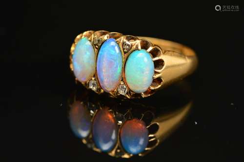 AN EDWARDIAN 18CT GOLD OPAL AND DIAMOND HALF HOOP RING, three oval opal cabochons measuring