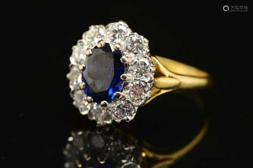 A MODERN 18CT DIAMOND AND SAPPHIRE OVAL CLUSTER RING, centring on an oval blue sapphire measuring