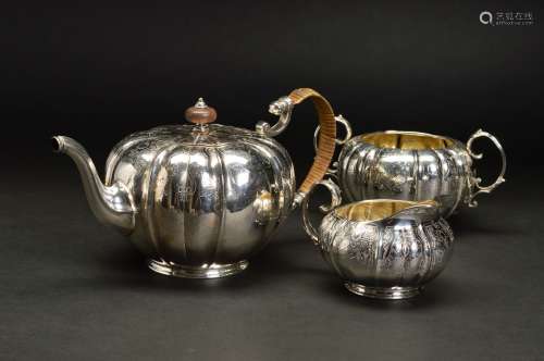 A LATE VICTORIAN SILVER THREE PIECE TEASET, of lobed circular form with engraved cartouches and