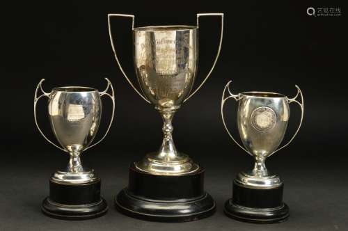 A GEORGE V SILVER TWIN HANDLED TROPHY CUP, knopped stem with a circular foot, engraved 'THE C.C.O