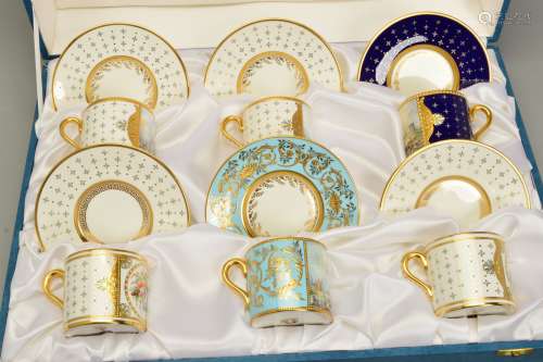 A CASED HARLEQUIN SET OF STEFAN NOWACKI CABINET COFFEE CUPS AND SAUCERS, four with cream ground