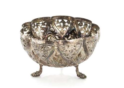 An early 20th century Indian silver bowl, ornately decorated with raised designs and pierced