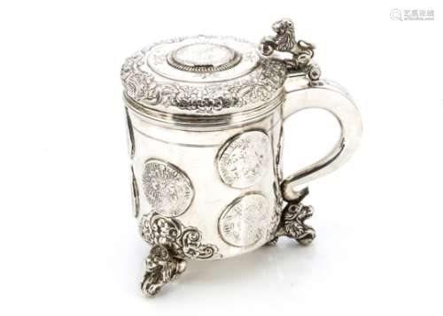 An 18th century Norwegian silver tankard, three lion and ball supports with raised and engraved