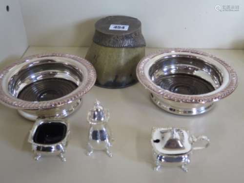 A silver plated hoof inkwell, a pair of plated coasters and a plated cruet
