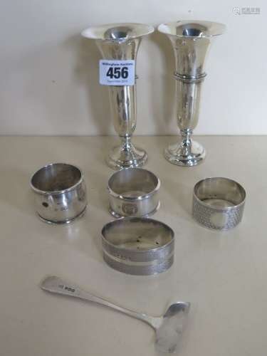 Four silver napkin rings, a pusher and two bud vases, weighable silver approx 3.6 troy oz, plus