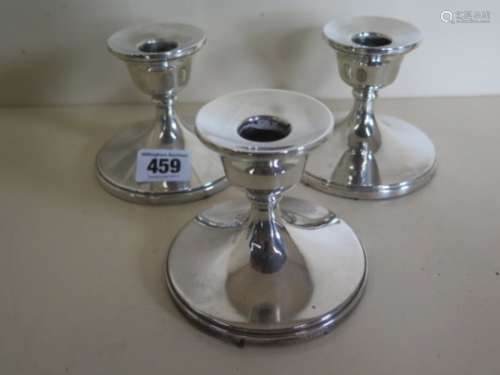 A set of three weighted silver candlesticks, by Henry Clifford Davis of Birmingham 1958 - height