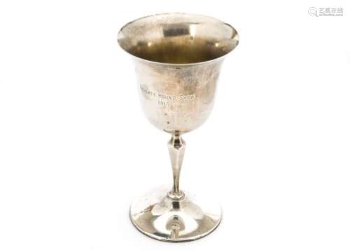 A George V silver trophy by Edward Barnard & Sons, the goblet engraved 