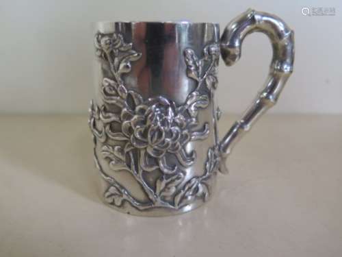 A Chinese silver christening mug of high quality stamped Shanghai Luen-Wo, decroated with applied