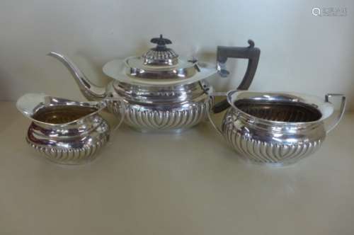 An Edwardian silver three piece tea service, hallmarked Birmingham 1903, maker EJ Partridge, total