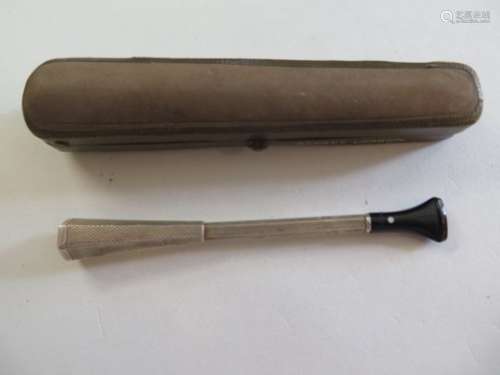 A silver cigarette holder by Alfred Dunhill, with black Bakelite mouth piece, spring loaded eject