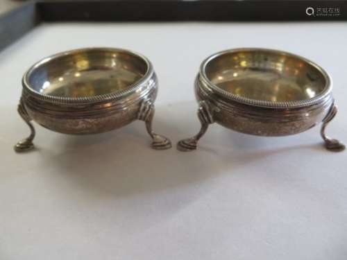 A pair of Georgian silver salts, standing on three legs, with stepped hoof feet, hallmarked London