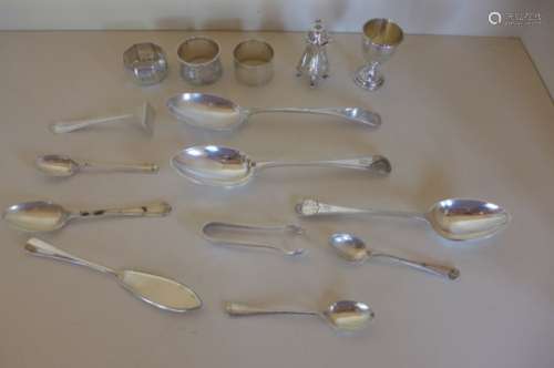Ten pieces of silver flatware, three silver serviette rings, a silver pepper and a silver egg cup,