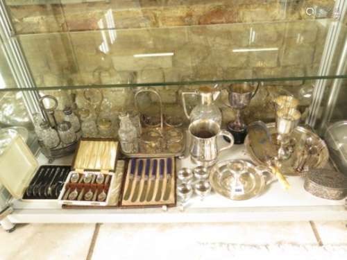 A large collection of silver plated items, to include a tray, tankard, cutlery, cruets, claret jug