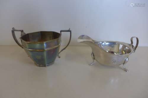 A silver sauce boat and a silver sugar bowl, both engraved, dents to bowl, otherwise generally good,