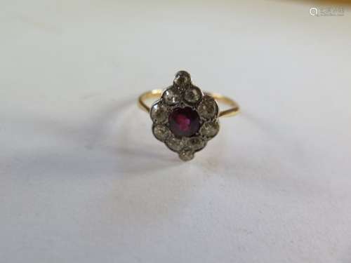 An 18ct diamond and ruby cluster ring, approx 15x10mm, ring size R, approx 3 grams, some bending