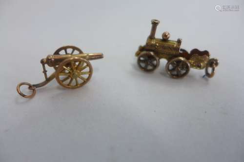 Two 9ct gold charms, a canon and a steam engine, weight approx 3.4 grams