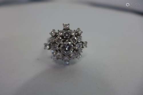 A very good diamond cluster ring in a five tier setting, the central stone measuring 0.5ct,