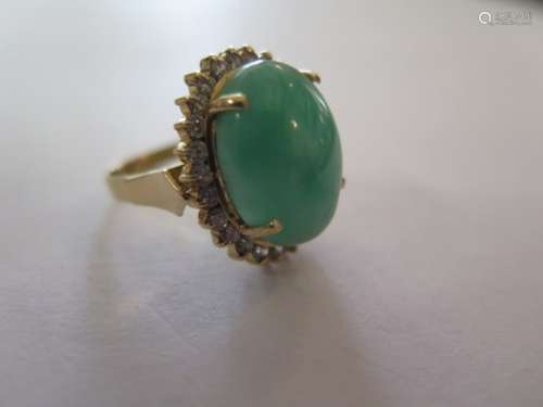 A stunning jade and diamond 18ct gold ladies ring, the central jade stone measuring 17.4 x 13.2mm,