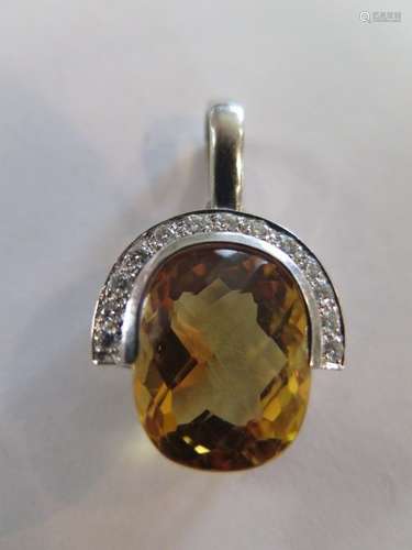 An 18ct white gold diamond ans citrine pendant, the central citrine or tourmaline measuring 17.5mm x