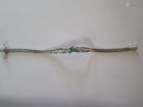 A very good emerald and diamond bracelet set in 14ct white gold, the emerald measuring approx 0.