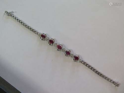 A stunning ruby and diamond bracelet set in 18ct white gold, set with five rubies each of approx 0.